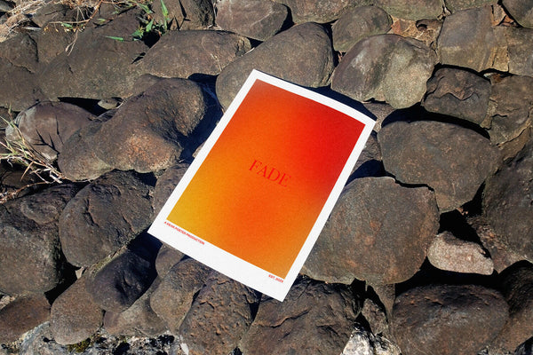 Flaming Fade minimalist Danish art poster with soft red gradients on enhanced matte paper. Poster placed in nature.